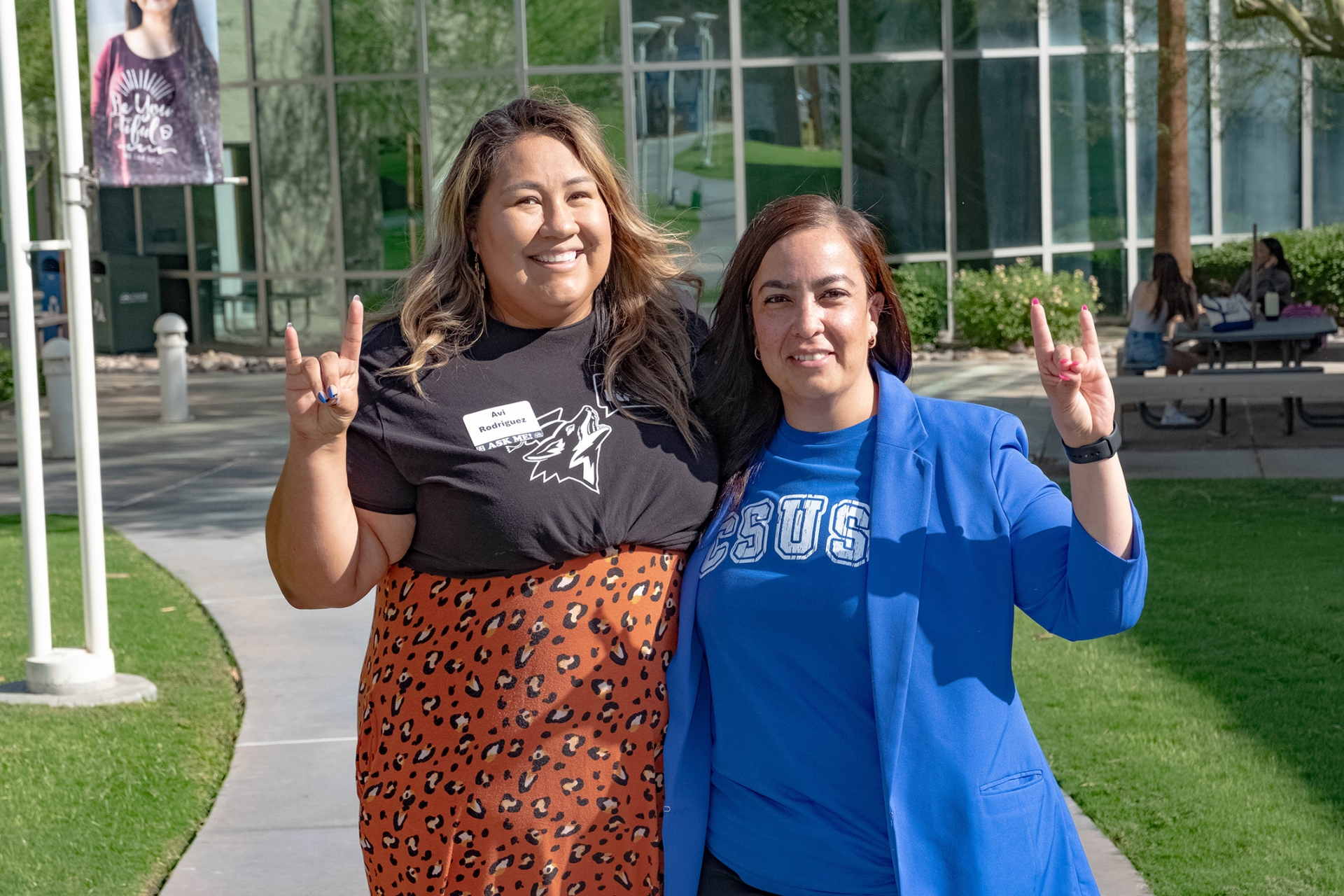 Avi Rodriguez (left), interim assistant dean of student engagement and Edna Martinez, associate vice president and administrator in charge at PDC, give the Coyote salute.