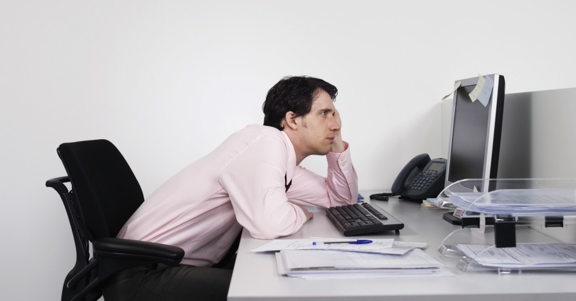 Employee with poor posture slouching at their desk