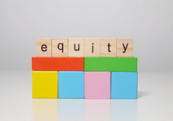 wooden blocks with word equity on top of colorful blocks