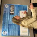 Natalya Marsh explains her study, published in the journal Frontiers, to an interested visitor. Her research explores how attitudes towards police might influence the interpretation of police officers' emotional expressions.