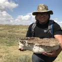 Student with fossiliferous sandstone