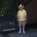 Guy standing next to manure dump