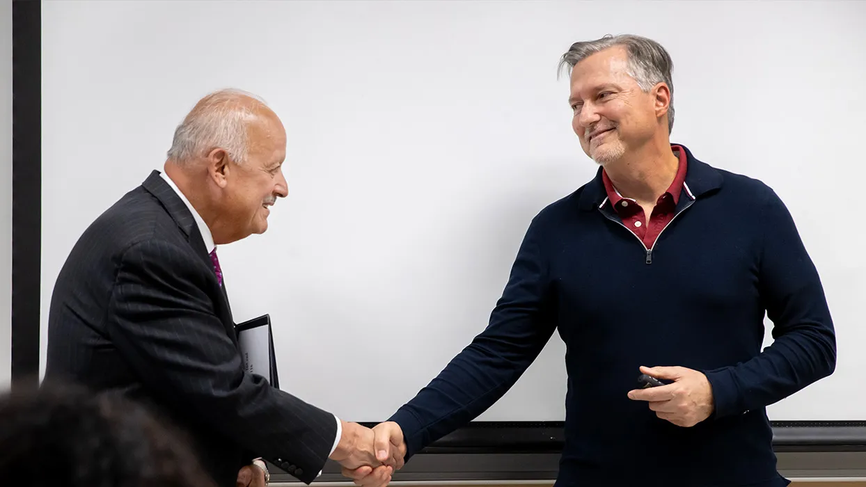 CSUSB President Tomás D. Morales congratulates Matthew Habich, a lecturer in the Jack H. Brown College of Business and Public Administration, on winning the 2023-24 Outstanding Lecturer Award.