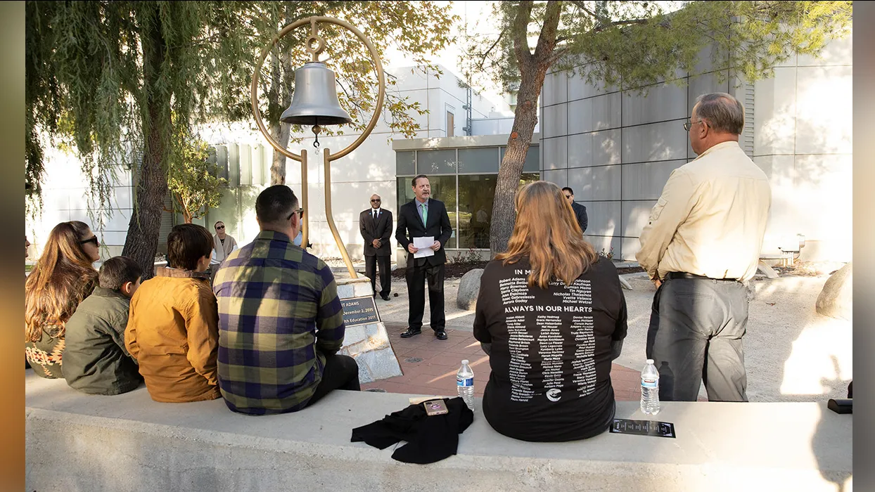 William Vandyke (center), a CSUSB health science and human ecology faculty member, speaks at the annual Day of Remembrance ceremony at CSUSB on Dec. 2, 2023.