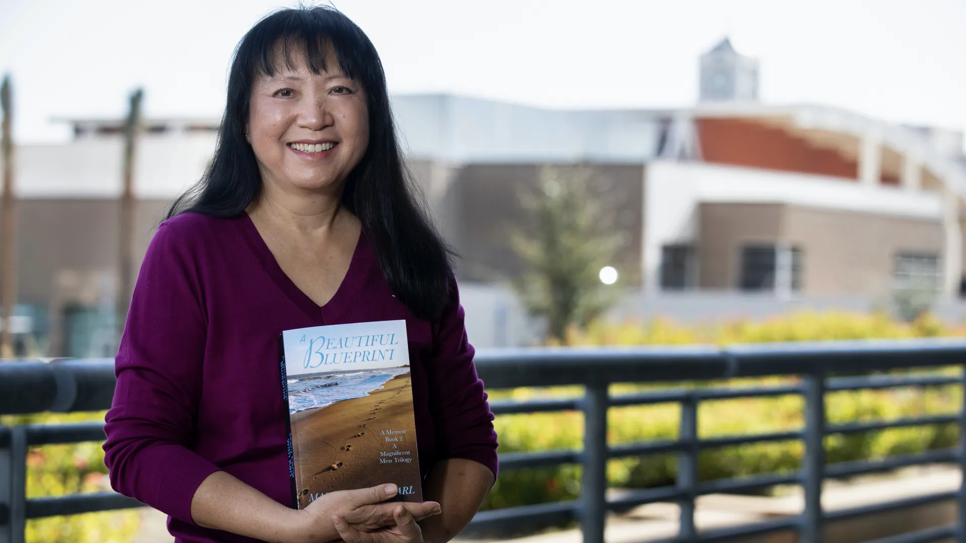 CSUSB professor Mary Fong holding her memoir