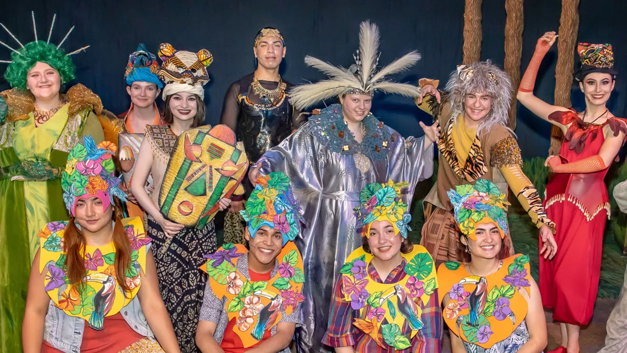The cast of CSUSB's “Anansi’s Carnival Adventure” posing in their colorful costumes and masks.