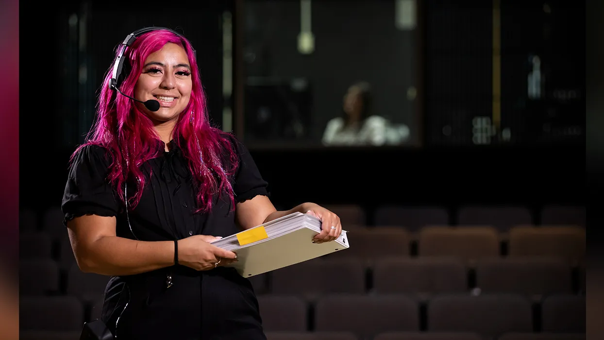 Isabel Peña working in the CSUSB Ronald E. Barnes Theatre.