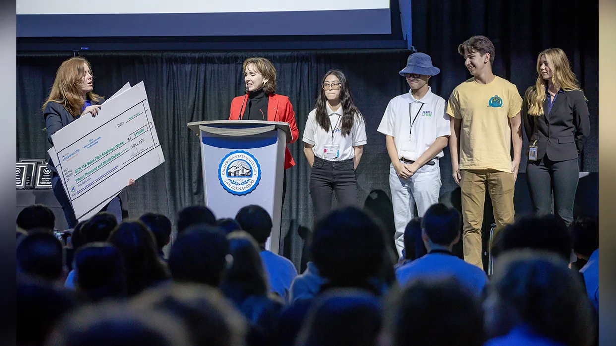 Stage photo of a team being awarded at the 2023 Virtual Enterprise International – West Coast Regional Tradeshow, Competition and Exhibition.