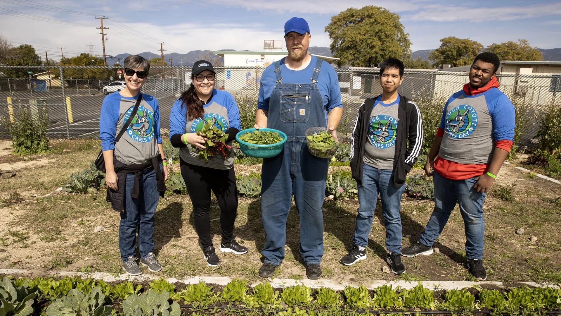 From left, Kristen Stutz, director of the Student Assistance in Learning (SAIL) program at CSUSB; student Sandra Garcia; contract farmer Kevin Head; student CJ Silvestre; and Terrence McCullough, at the Anne Shirrells Community Garden during the 2023 Coyote Cares Day at the Akoma Unity Center in San Bernardino.