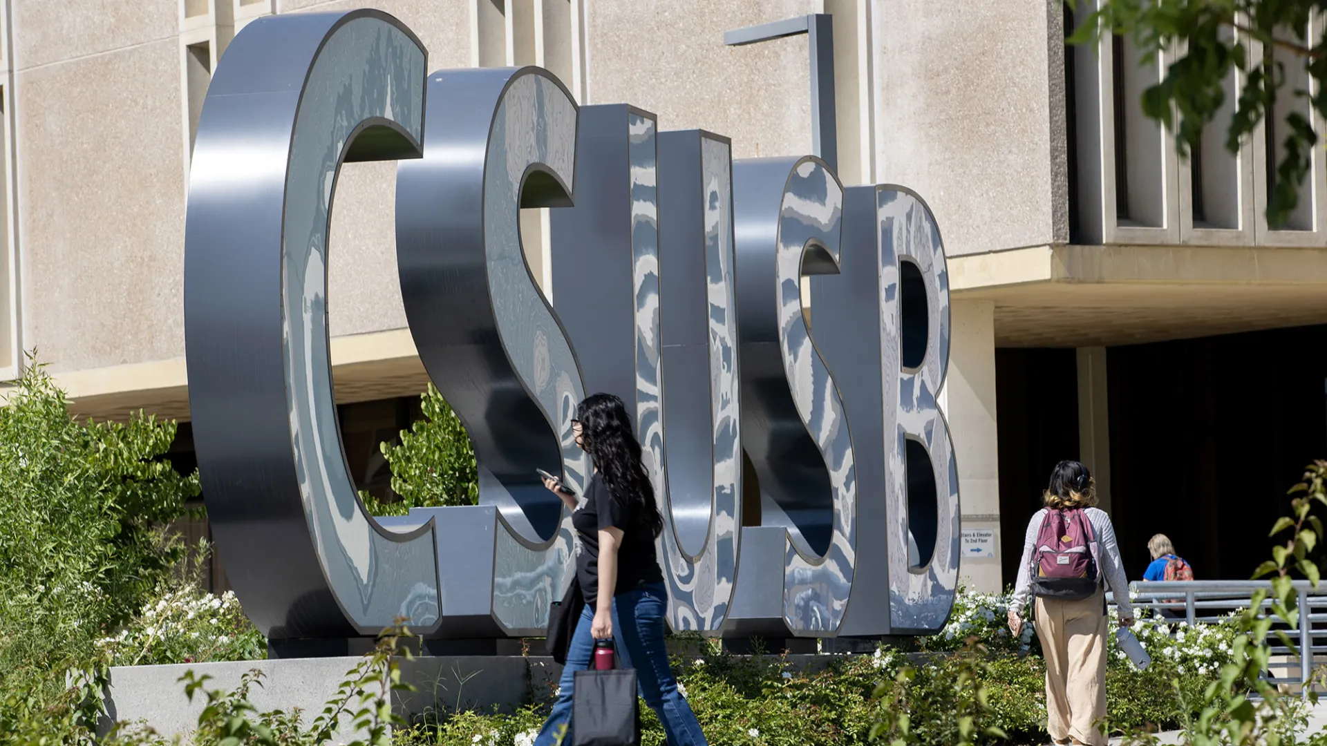 Students by the CSUSB spirit letters