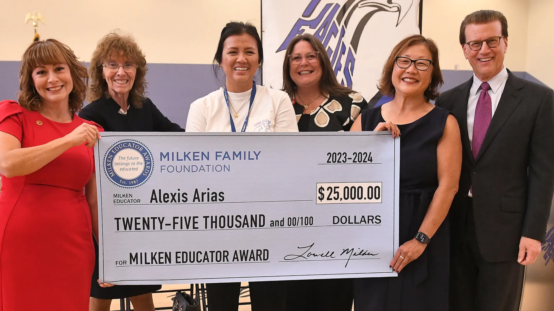 Alexis Arias receives $25,000 ceremonial check for Milken Educator Award.