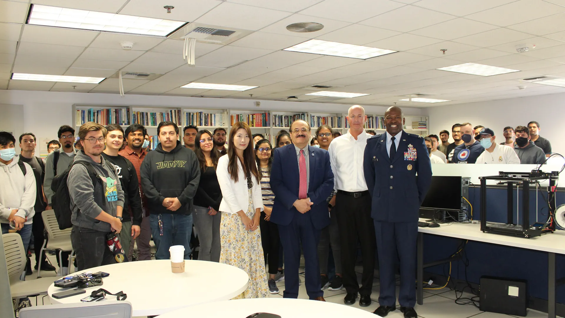 Beginning at center left, Jennifer Jin (in the white jacket), assistant professor, School of Computer Science and Engineering; Khalil Dajani, director and professor, School of Computer Science and Engineering; Stephan Ewart, U.S. Air Force Head of Engineering Squadron; Air Force Col. Ahave Brown Jr., commander of 412 MXG Squadron; with students who attended an Oct. 26 event at CSUSB.