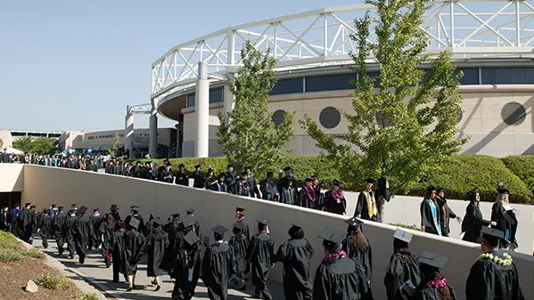 Graduates walking to commencement 