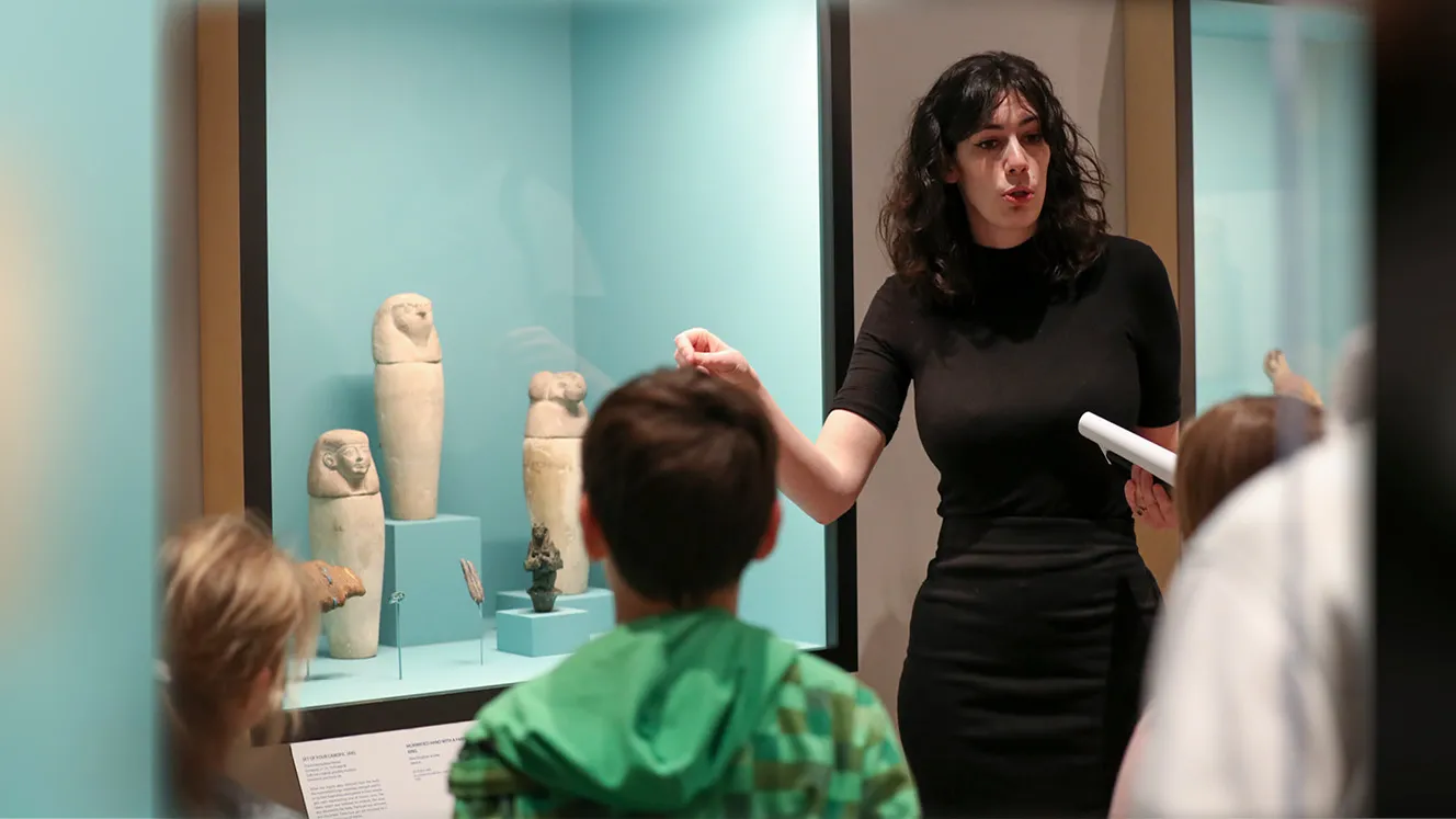 Jessica Tomkins, a past W. Benson Harer Egyptology Scholar in Residence at CSUSB, showing young students some of the Ancient Egypt collection at the university’s Robert and Frances Fullerton Museum of Art.