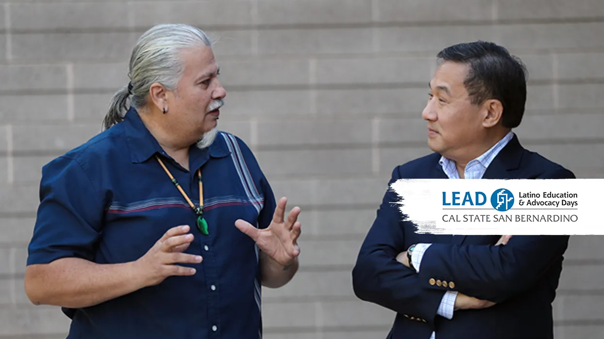 Enrique Murillo Jr. (l), Professor of education an executive director of LEAD, is interviewed by PBS NewsHour reporter John Yang