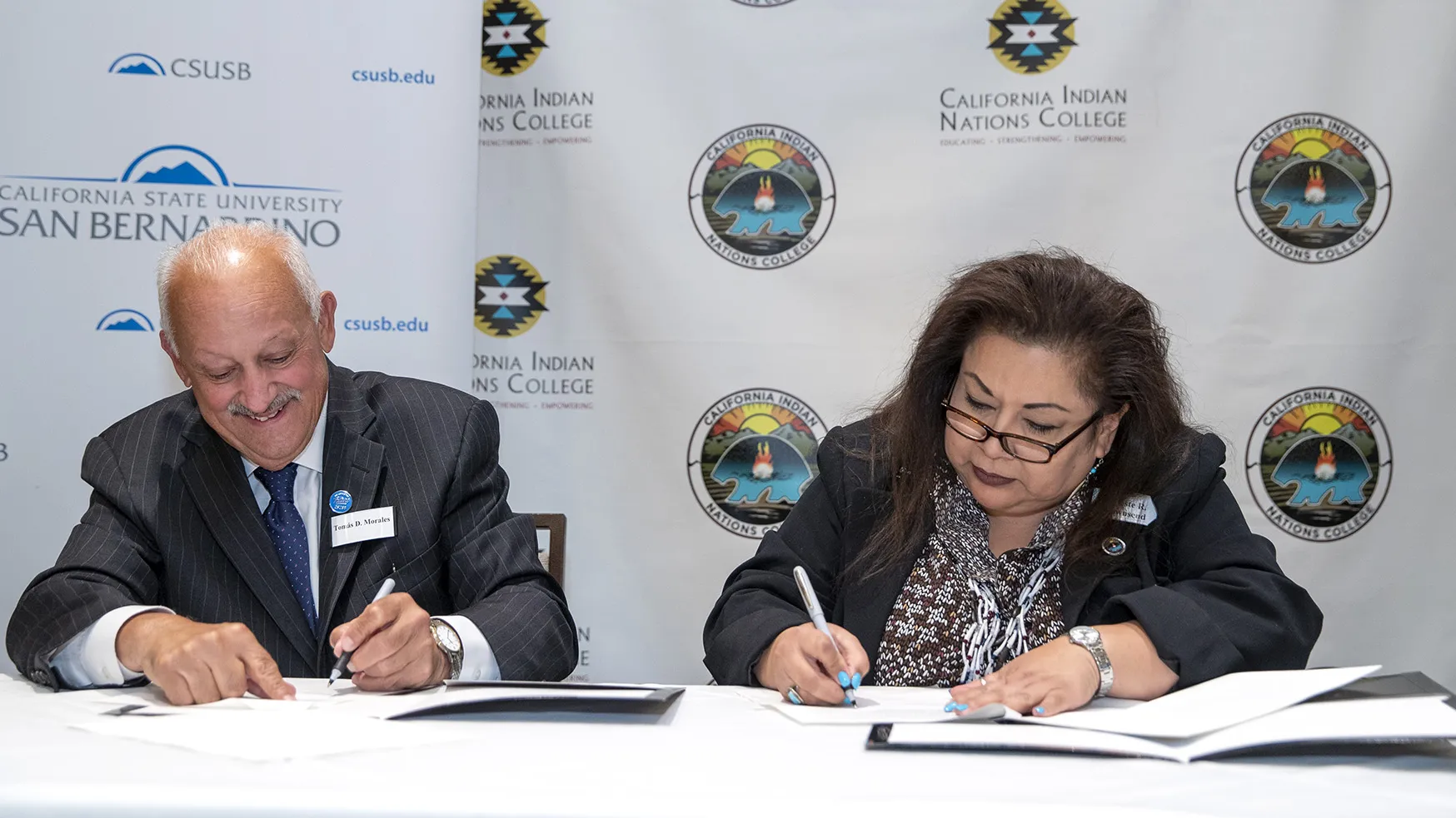 Tomás D. Morales, left, President of California State University, San Bernardino, and Celeste Townsend, President and Chief Executive Officer, California Indian Nations College, sign an MOU at Classic Club in Palm Desert, on Tuesday, October 4, 2022.