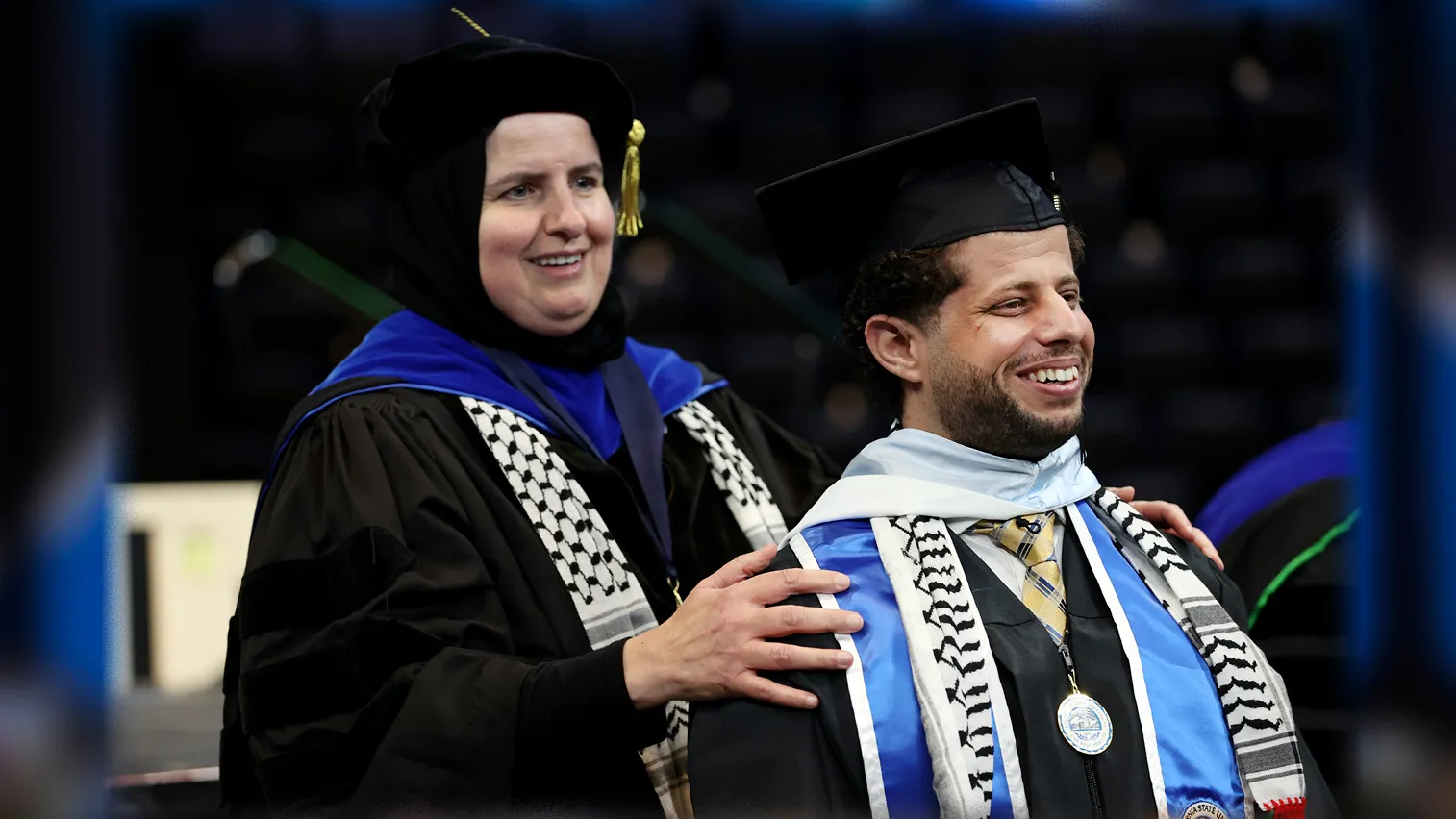 Naim Aburaddi (right) and Ahlam Muhtaseb, professor of media studies, at the CSUSB spring 2022 commencement ceremony on May 21.  