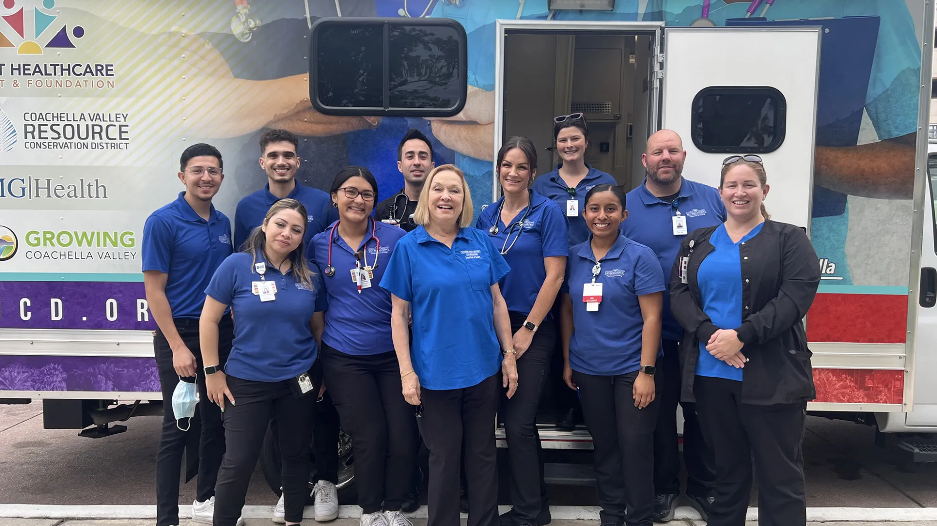 Members of the CSUSB Nursing Street Medicine Program pose in front of a mobile medical clinic.