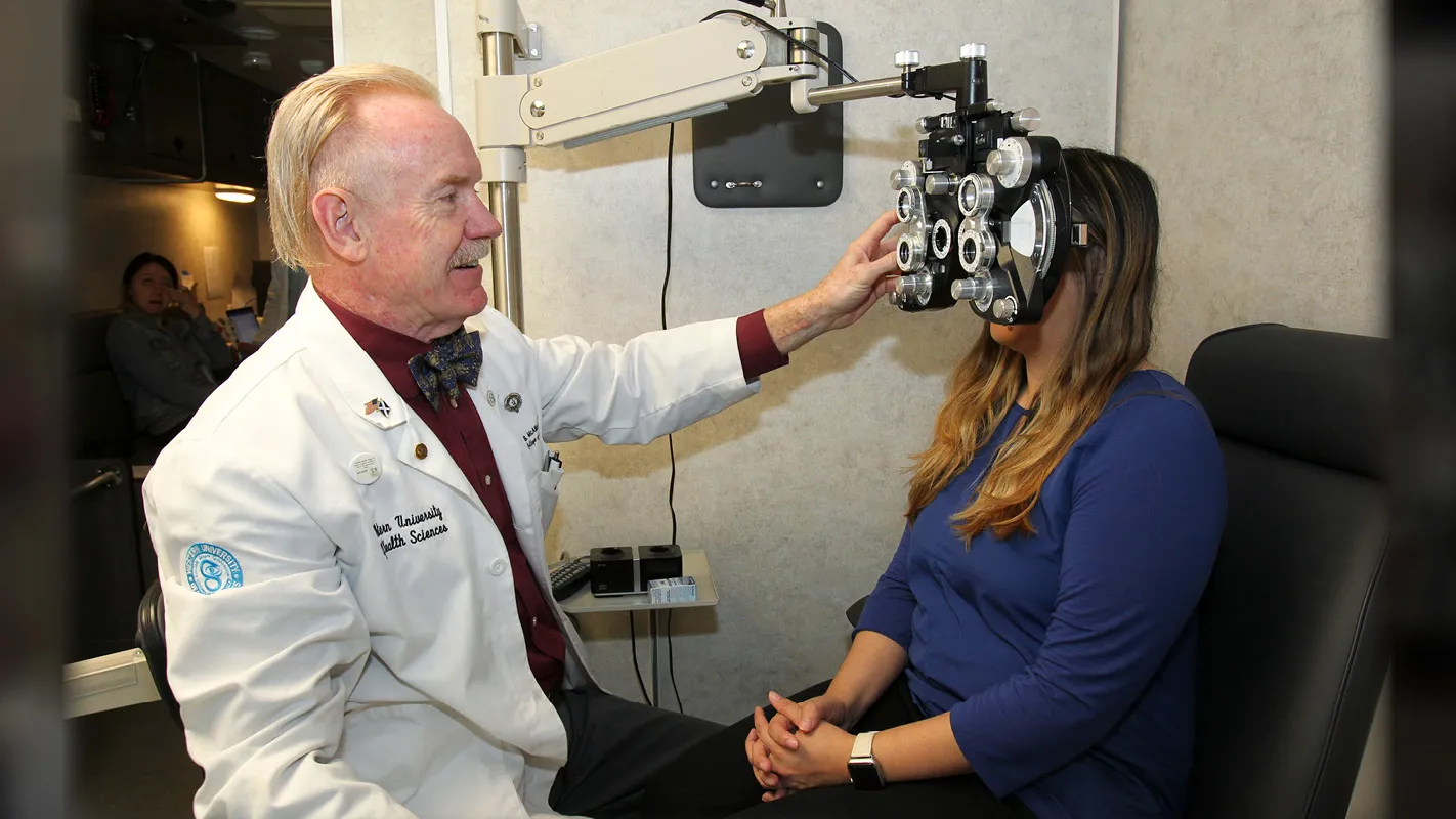 Dr. Bennett McAllister conducts an eye exam at the mobile eye clinic