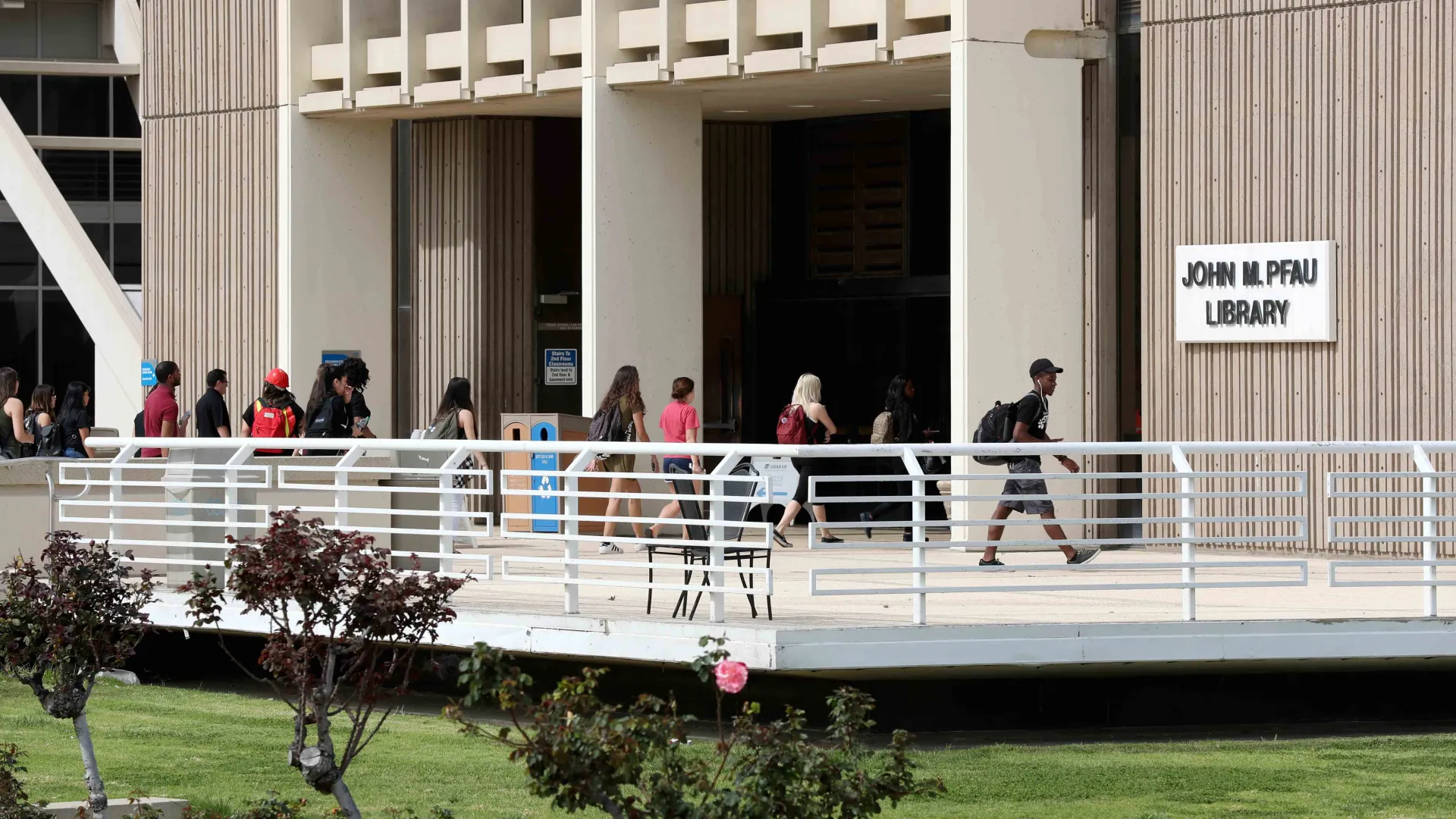 Students at the Pfau Library entrance