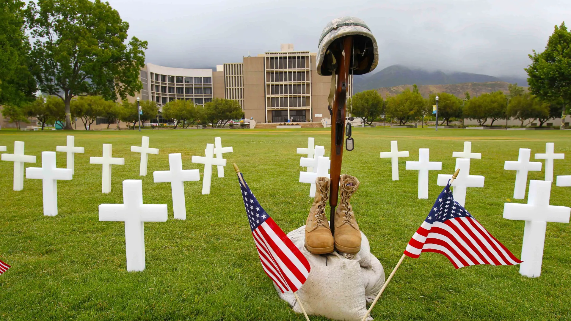 Rifle, helmet, boots, flags and crosses from a Memorial Day event on campus, file photo.