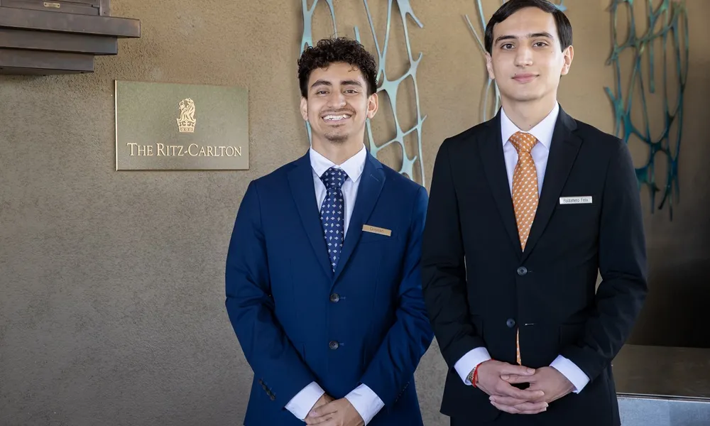 2 alumni wearing suits at the Ritz Carlton