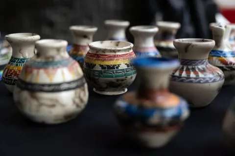 A vendor sells pottery items at the California Native American Day celebration at the state Capitol on Sept. 22, 2023. Photo by Miguel Gutierrez Jr., CalMatters