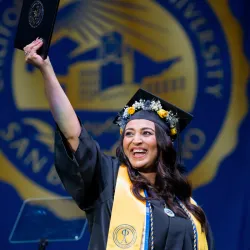 A graduate celebrating at CSUSB’s College of Social and Behavioral Sciences Spring Commencement ceremony held in May. 