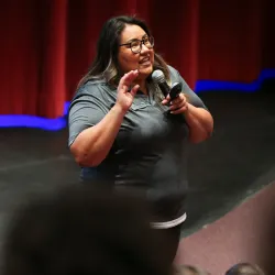 Avi Rodriguez speaking in front of a crowd 