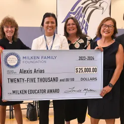 Alexis Arias receives $25,000 ceremonial check for Milken Educator Award.