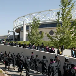 Graduates walking to commencement 