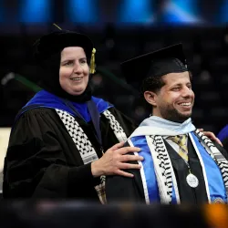 Naim Aburaddi (right) and Ahlam Muhtaseb, professor of media studies, at the CSUSB spring 2022 commencement ceremony on May 21.  