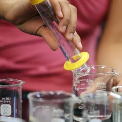 Student’s hands shown working in a lab setting