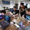 Students working together on a laptop.