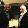 Two people holding award