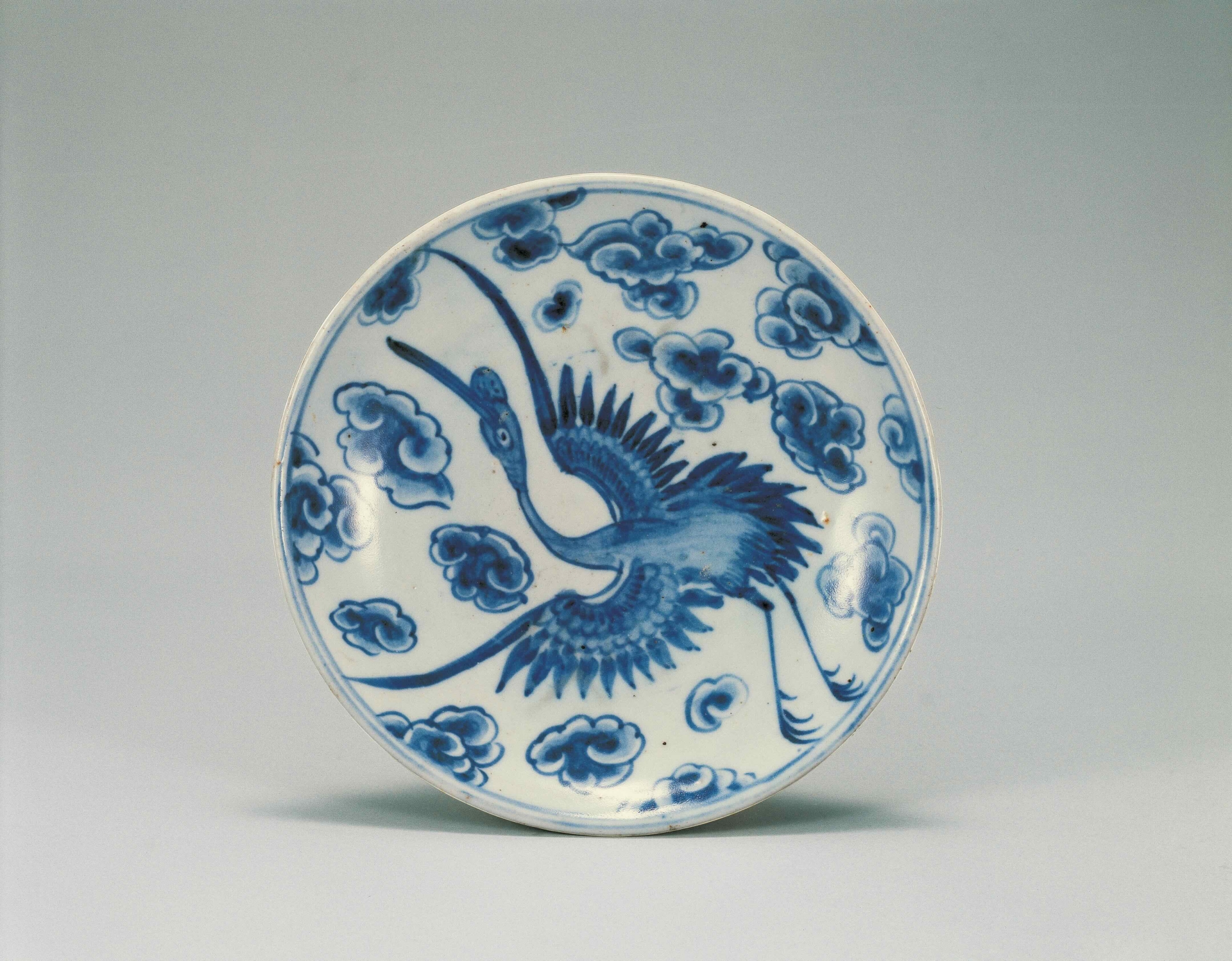 Blue and whit porcelain plate with cloud crane design