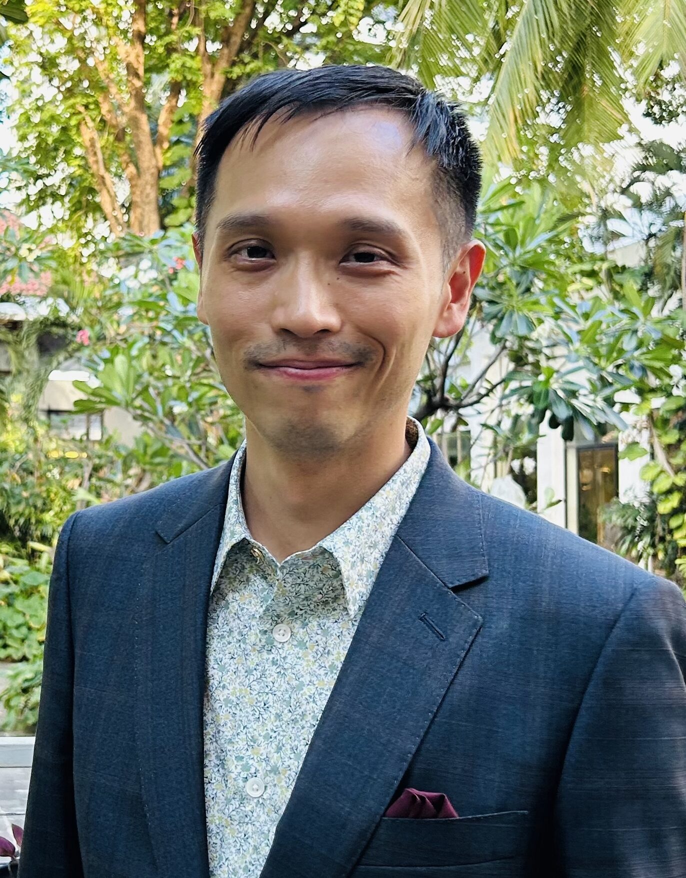 Howard Chiang, short dark hair, blue jacket and white shirt, smiling