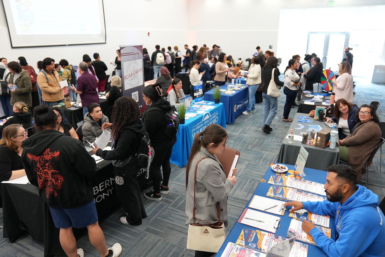 A crowded job fair with attendees exploring career opportunities and networking.