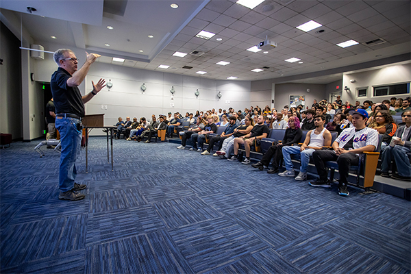 CSUSB’s Center for Cyber & AI Executive Director Tony Coulson presents to an audience at the Oct. 25 open house.