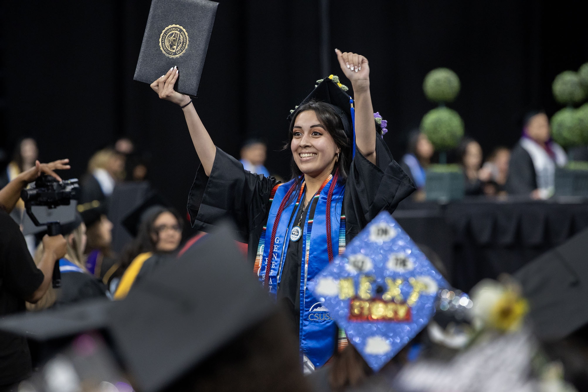 A female graduate celebrates at the CSBS Commencement ceremony on May 17.