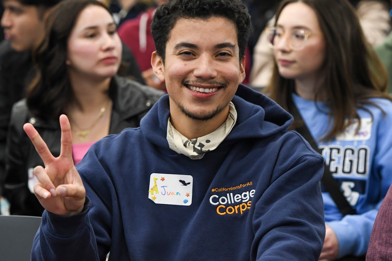 College Corps participant making a peace sign gesture