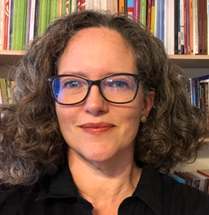 Karen Rowan in front of a book case. 