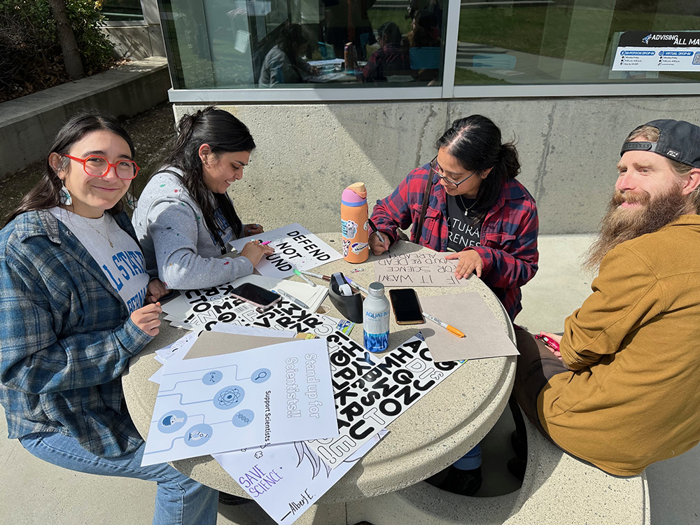 Students making posters at Standup For Science event