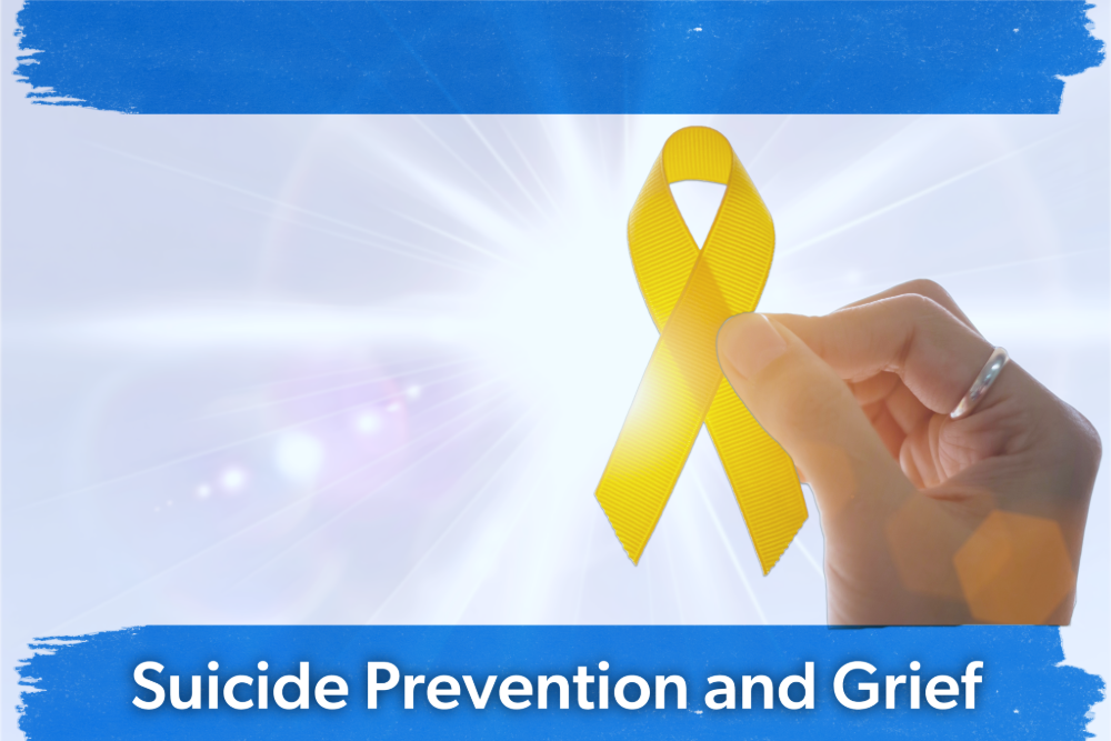 A hand holding a yellow ribbon symbolizing support in suicide prevention and grief. Bright light shines from behind, with blue text below.