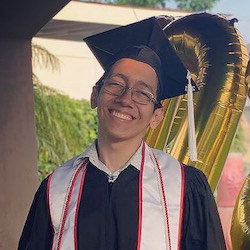 photograph of Alberto Diaz smiling in cap and gown