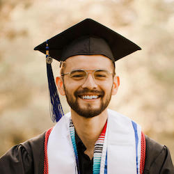 photo of Jonatan Montanez smiling in graduation cap and gown