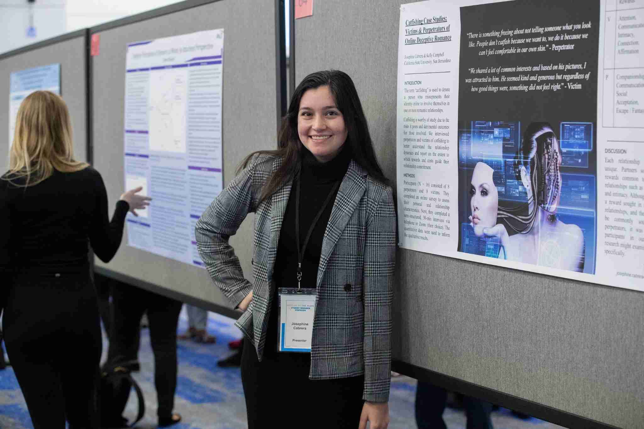 Student standing by poster presentation